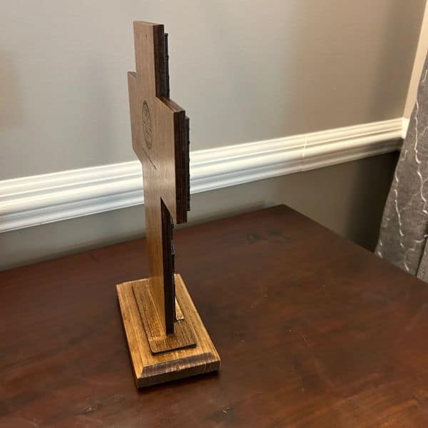 Wooden puzzle piece standing upright on a wooden base, demonstrating craftsmanship and woodworking art.