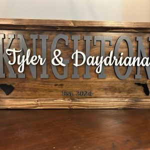 Family name sign with personalized names Tyler & Daydriana, carved wooden frame, perfect for home decor and family celebrations.